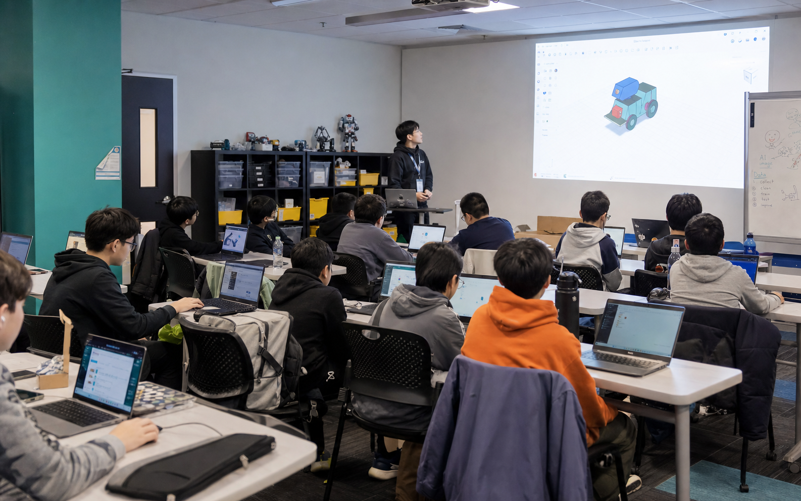 Students learning AI with laptops in a classroom workshop.
